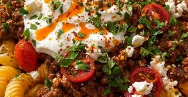 Delicious Turkish pasta dish by Anna Paul garnished with herbs.