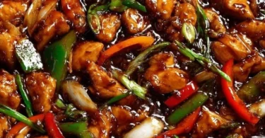 Delicious chicken in garlic sauce served on a plate with herbs.