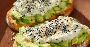 Cottage cheese avocado toast topped with fresh herbs and spices