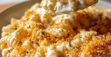 Delicious creamy Boursin mac and cheese in a bowl, topped with herbs.