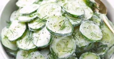 Fresh cucumber yogurt salad with herbs and spices, served in a bowl.
