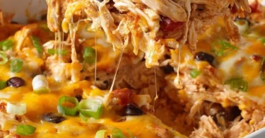 Healthy chicken taco casserole topped with fresh ingredients and served in a dish.