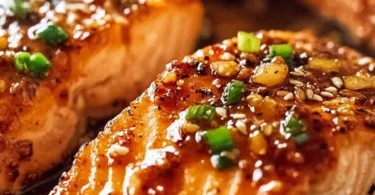 Delicious hot honey salmon garnished with herbs ready to serve