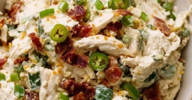 Jalapeño Popper Chicken Salad garnished with jalapeños and cheese.