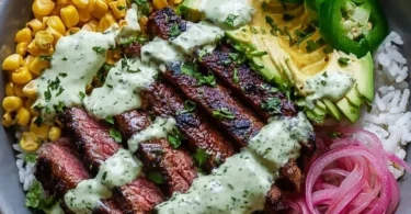 Steak bowl with avocado, roasted corn, and cilantro cream sauce
