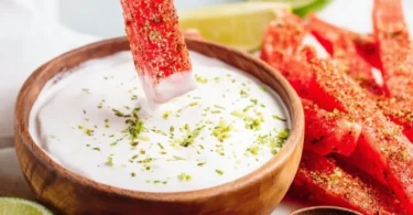 Tajin-coated spicy watermelon fries topped with chili seasoning
